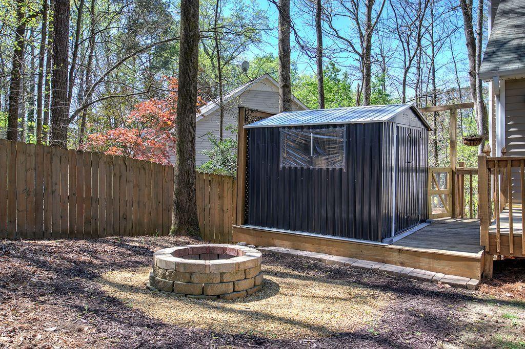 205 Cryder Lane Canton, GA 30115 - Photo 35 of 38 a backyard of house with a small yard and large trees