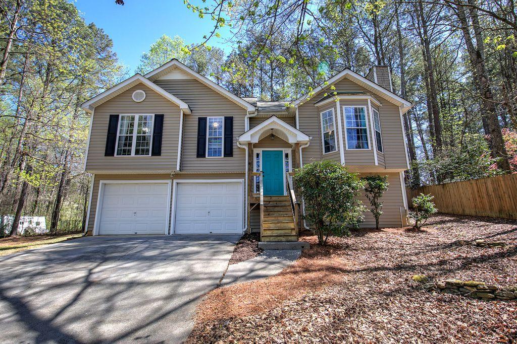 205 Cryder Lane Canton, GA 30115 - Photo 6 of 38 a front view of a house with a yard and garage