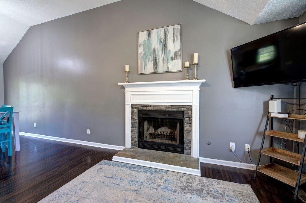 205 Cryder Lane Canton, GA 30115 - Photo 10 of 38 a living room with a fireplace and a flat screen tv