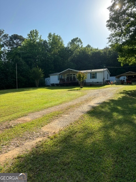 175 Springdale Road Jackson, GA 30233 - Photo 1 of 1 a front view of a house with a yard and garage