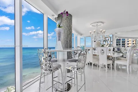 a dining room view with furniture and chandelier
