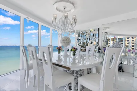 a view of a dining room with furniture and chandelier