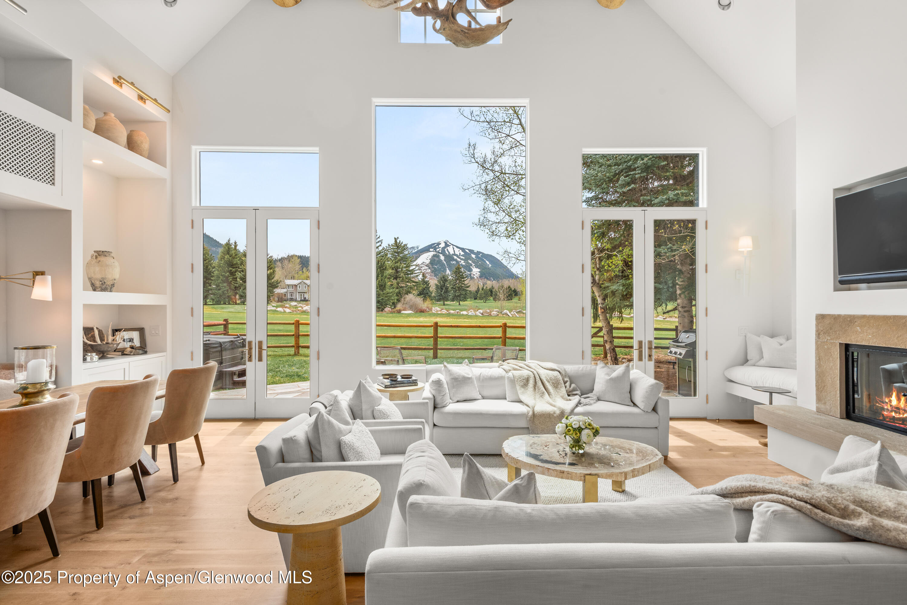a living room with fireplace furniture and a large window