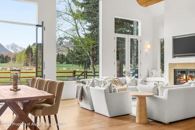 a bedroom with a bed and a large window with outer view