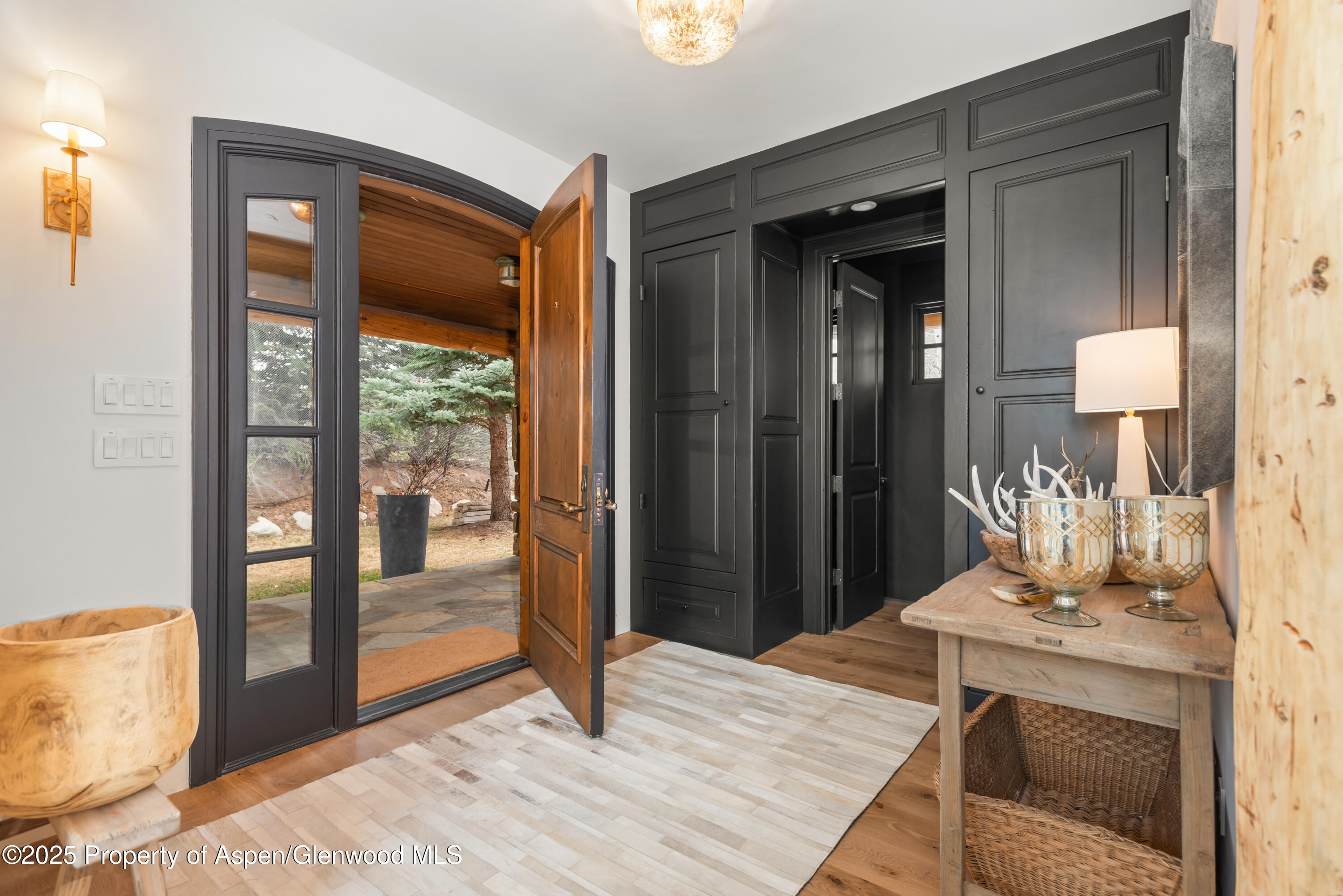 1495 Homestake Drive, Unit 2 Aspen, CO 81611 - Photo 6 of 42 a bedroom with a bed and a mirror