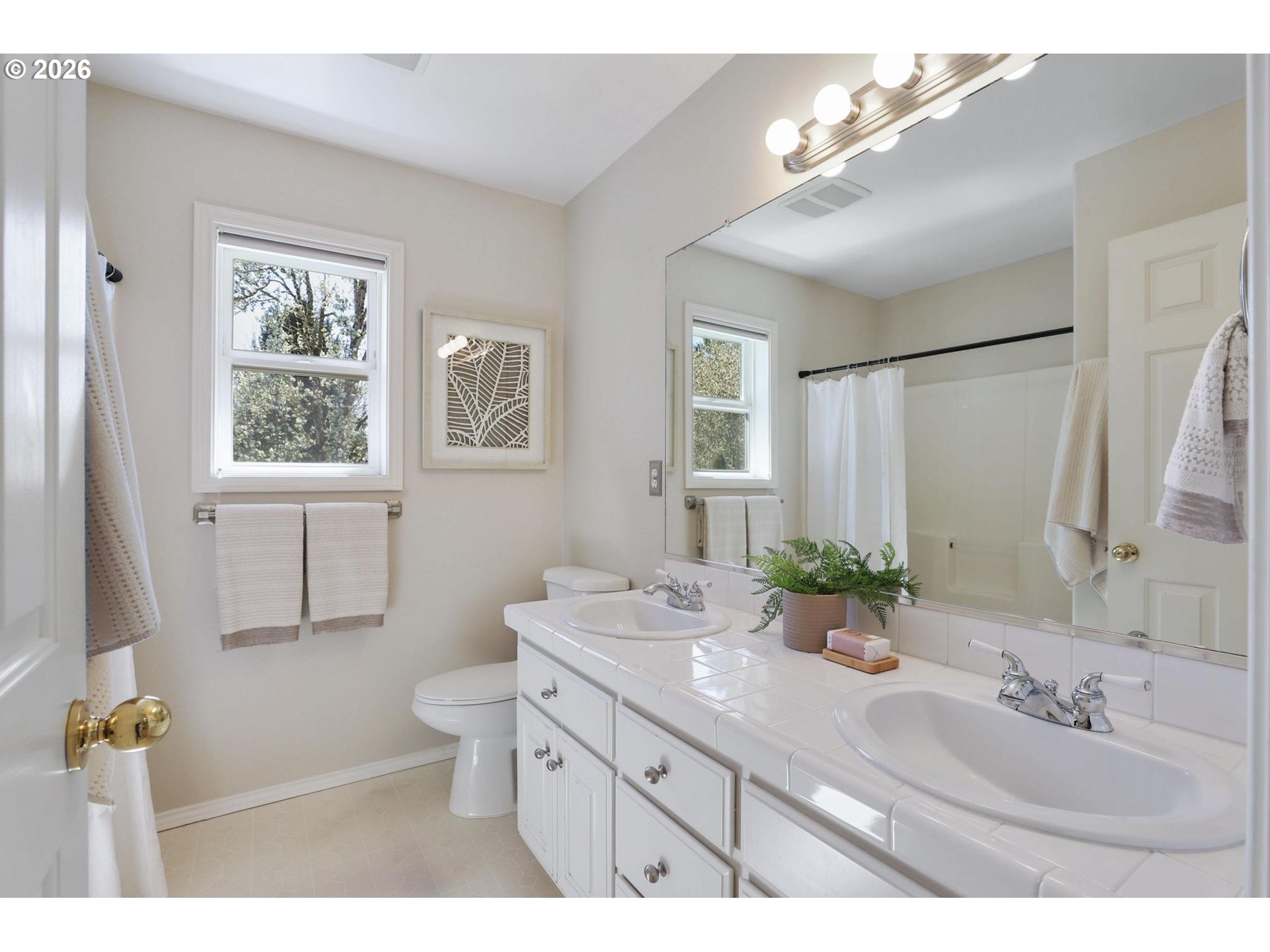 17650 Northwest Gilbert Lane Portland, OR 97229 - Photo 20 of 26 a bathroom with a double vanity sink toilet and a mirror