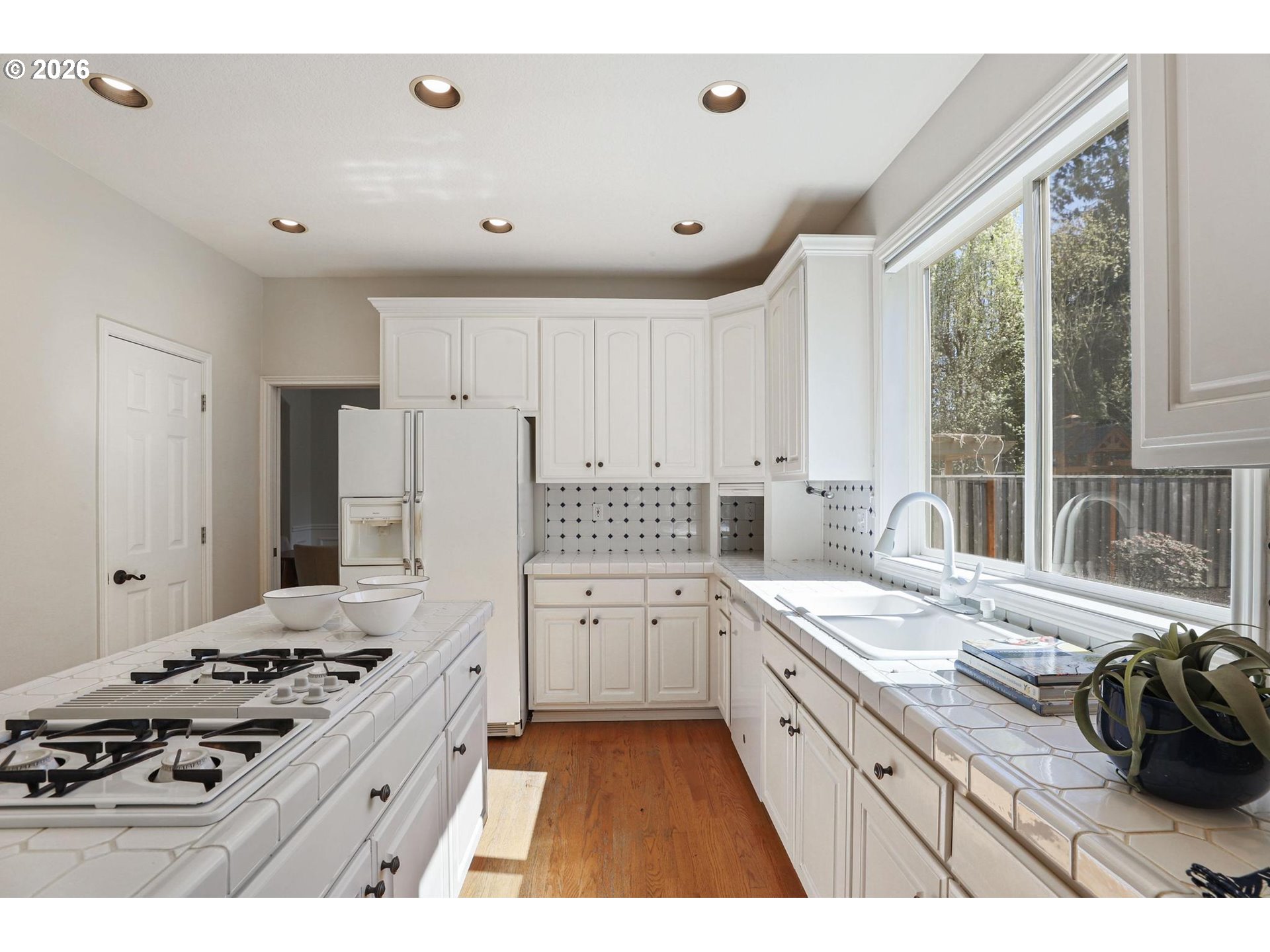 17650 Northwest Gilbert Lane Portland, OR 97229 - Photo 7 of 26 a kitchen with a stove a sink and a refrigerator
