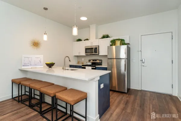 a kitchen with kitchen island a refrigerator stove and microwave