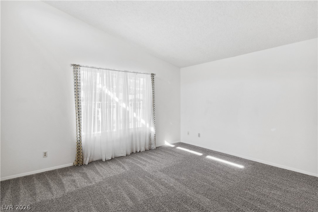 2146 High Dunes Lane Laughlin, NV 89029 - Photo 7 of 64 Family room with light colored carpet, a ceiling fan, light tile patterned flooring, and lofted ceiling