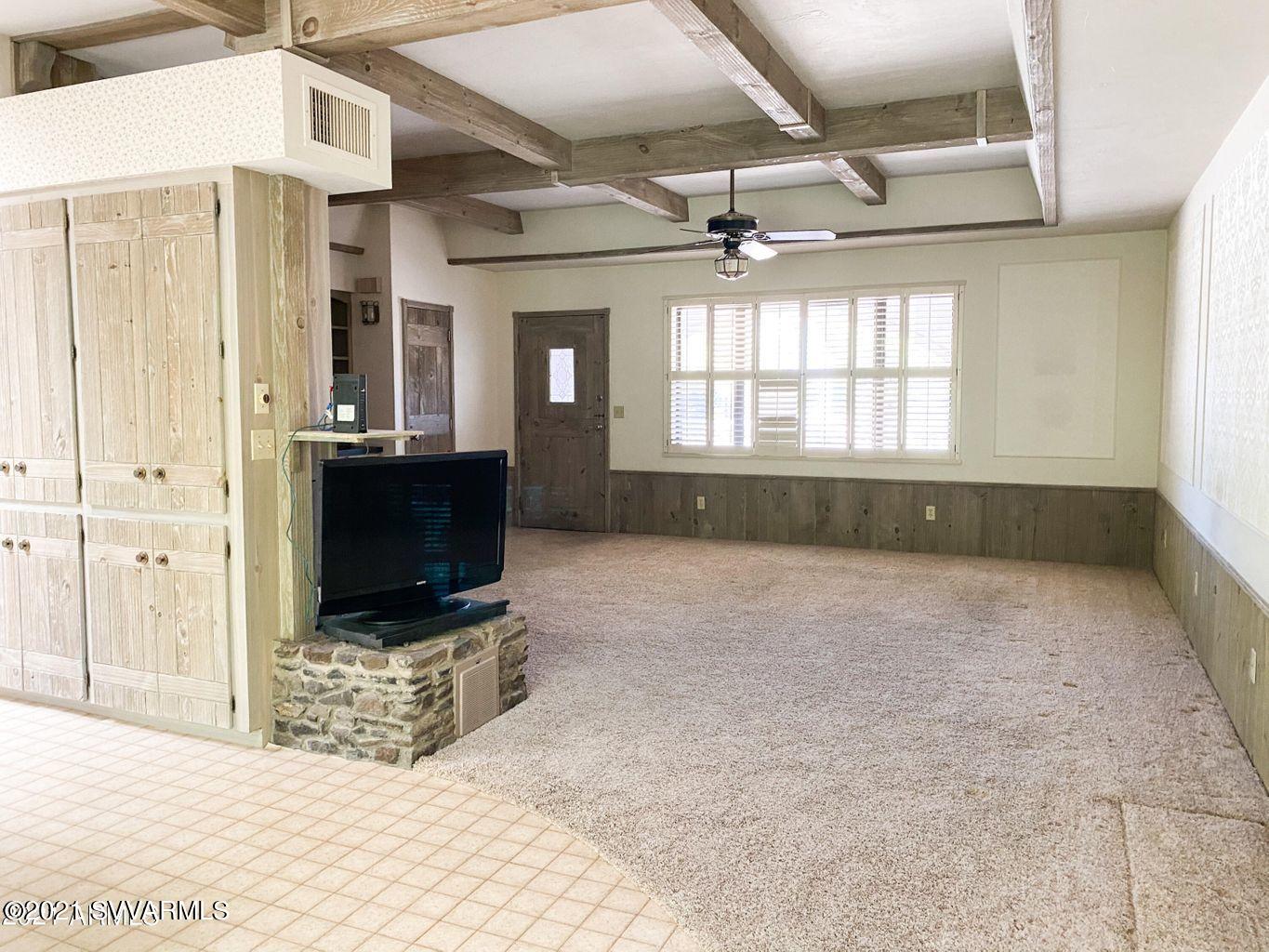 3260 East Rimrock Drive Rimrock, AZ 86335 - Photo 5 of 44 a view of an empty room with a fireplace and a window