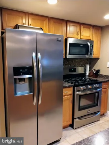 a kitchen with a stainless steel appliances and cabinets