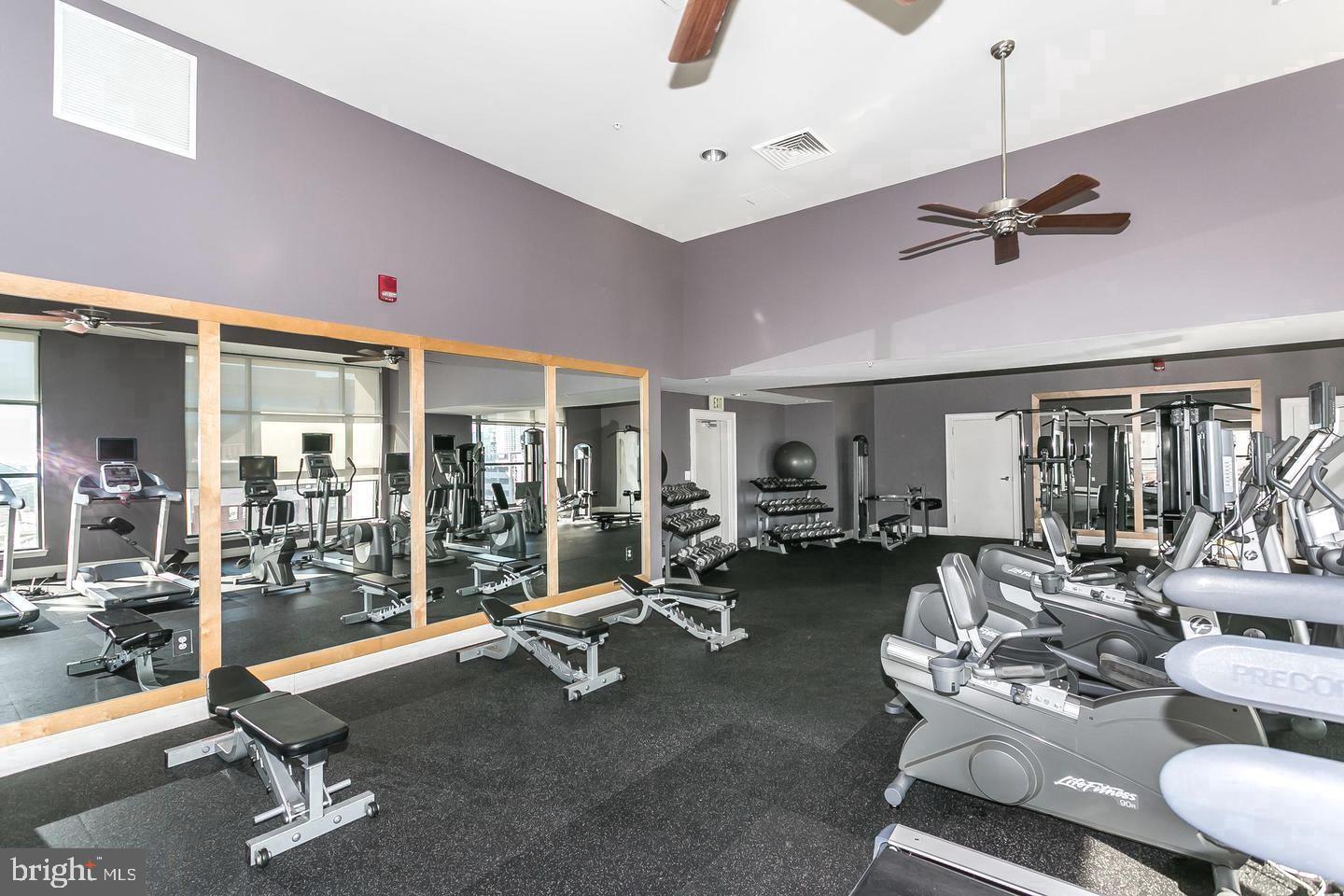 414 Water Street, Unit 1608 Baltimore, MD 21202 - Photo 10 of 26 a room with gym equipment and a large window