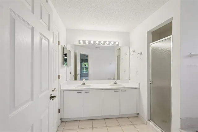 a bathroom with a double vanity sink mirror and