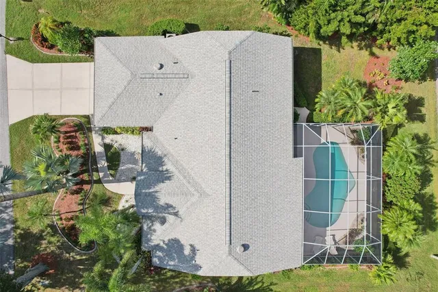 an aerial view of a house with a yard and potted plants