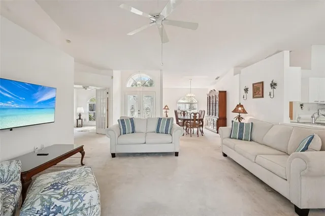 a living room with furniture and a chandelier