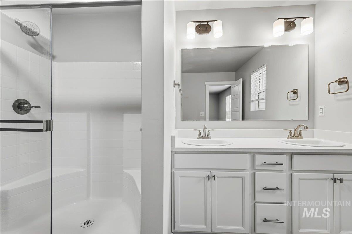 12475 West Victory Road Boise, ID 83709 - Photo 20 of 26 Shower with a glass enclosure and white subway tile surround