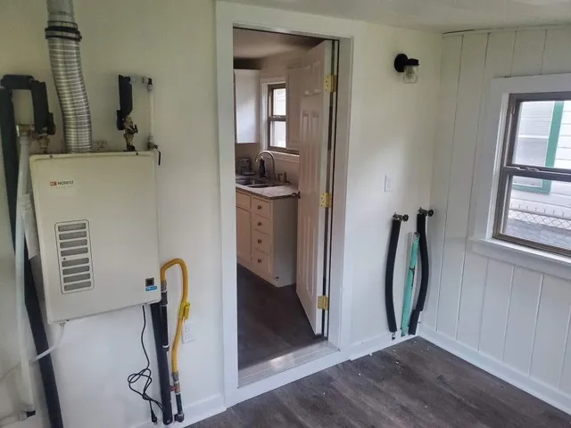 a view of a hallway with closet and mirror
