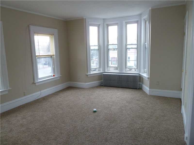 27 Kilvert Street Warwick, RI 02886 - Photo 13 of 18 Living Room. This is the living room on the second floor. All units are carpeted, but given the age of the home, it stands that htere may be hardwoods under.