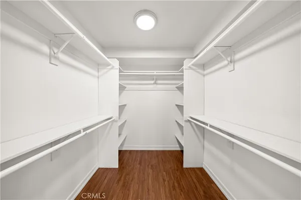 a view of closet with wooden floor