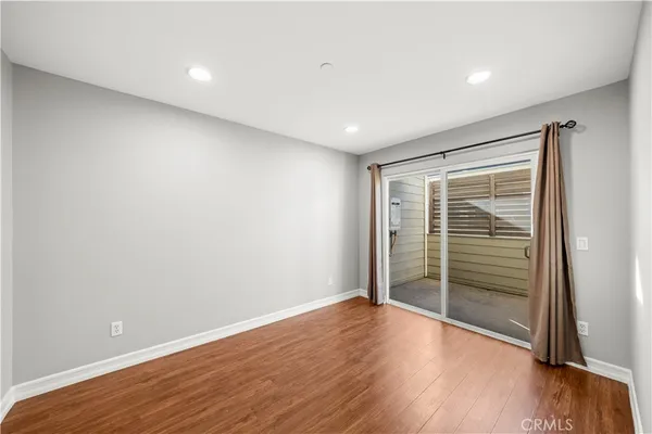 a view of room with wooden floor