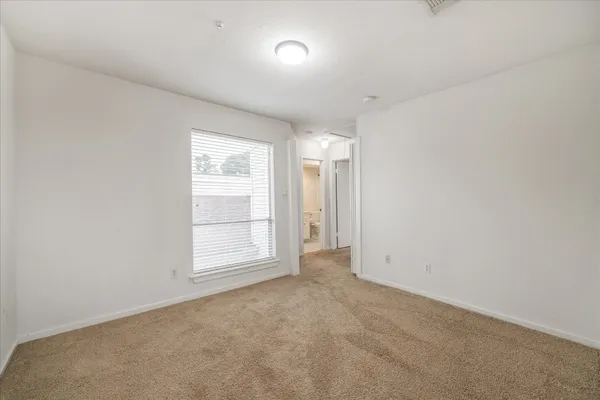 an empty room with a empty space and windows