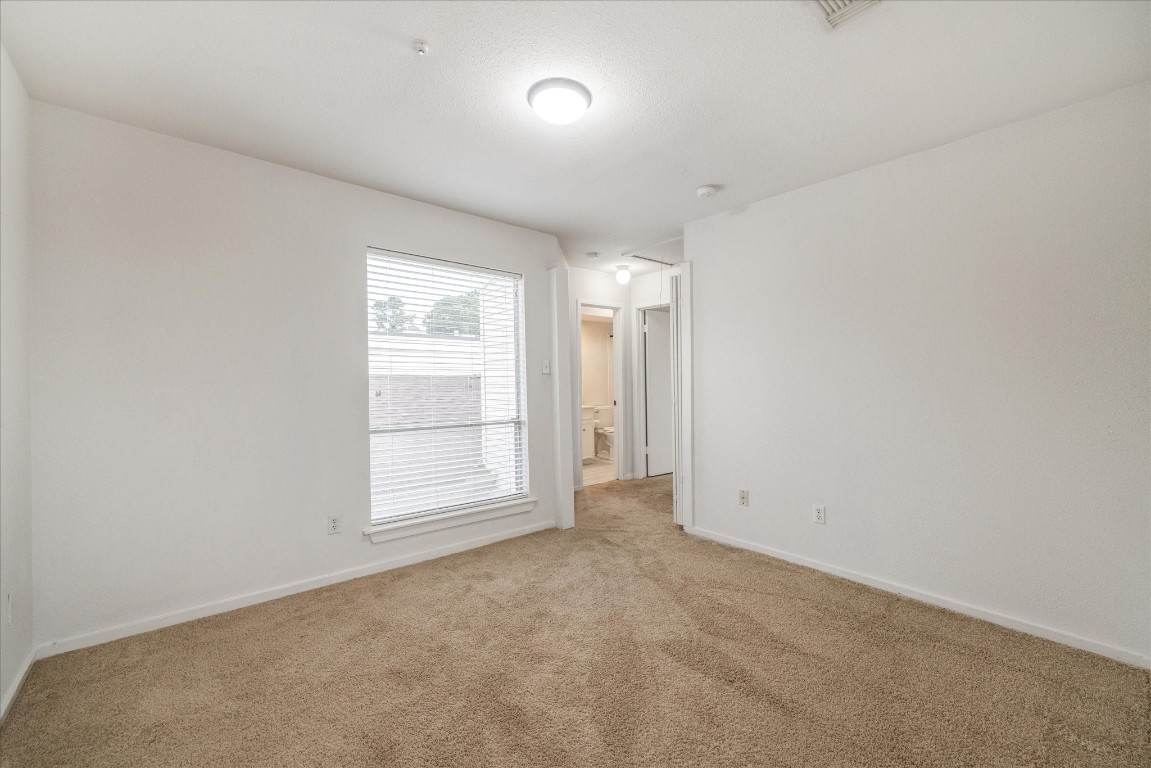 1864 South Gessner Road Houston, TX 77063 - Photo 14 of 17 an empty room with a empty space and windows