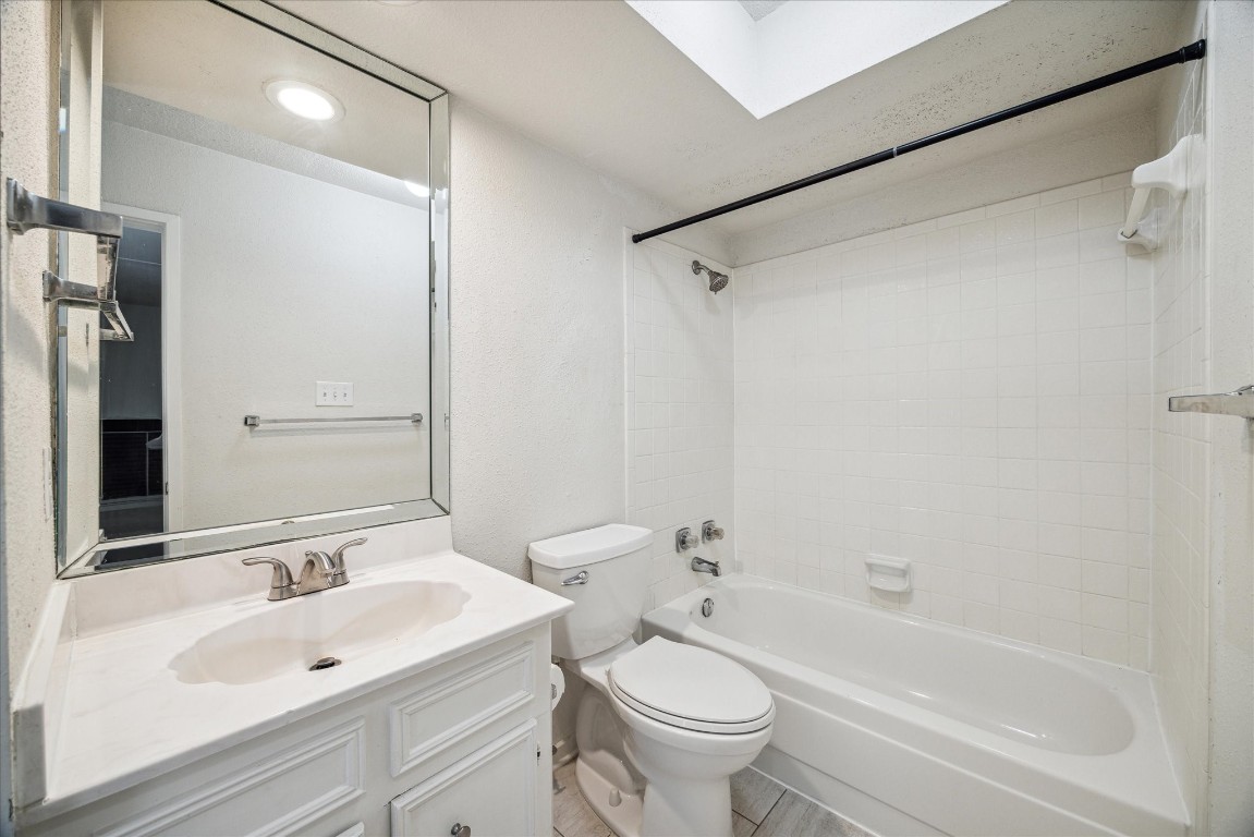 1864 South Gessner Road Houston, TX 77063 - Photo 16 of 17 a bathroom with a bathtub shower sink vanity mirror and toilet