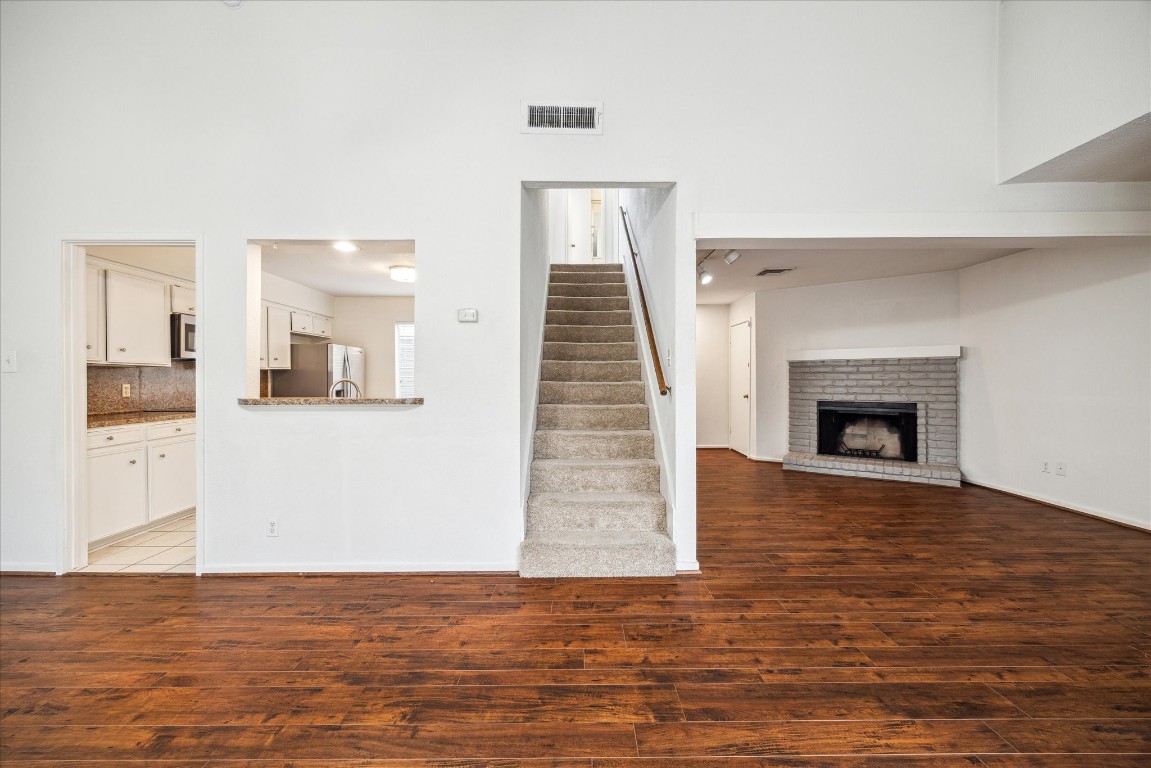 1864 South Gessner Road Houston, TX 77063 - Photo 5 of 17 a view of a livingroom with wooden floor and a fireplace