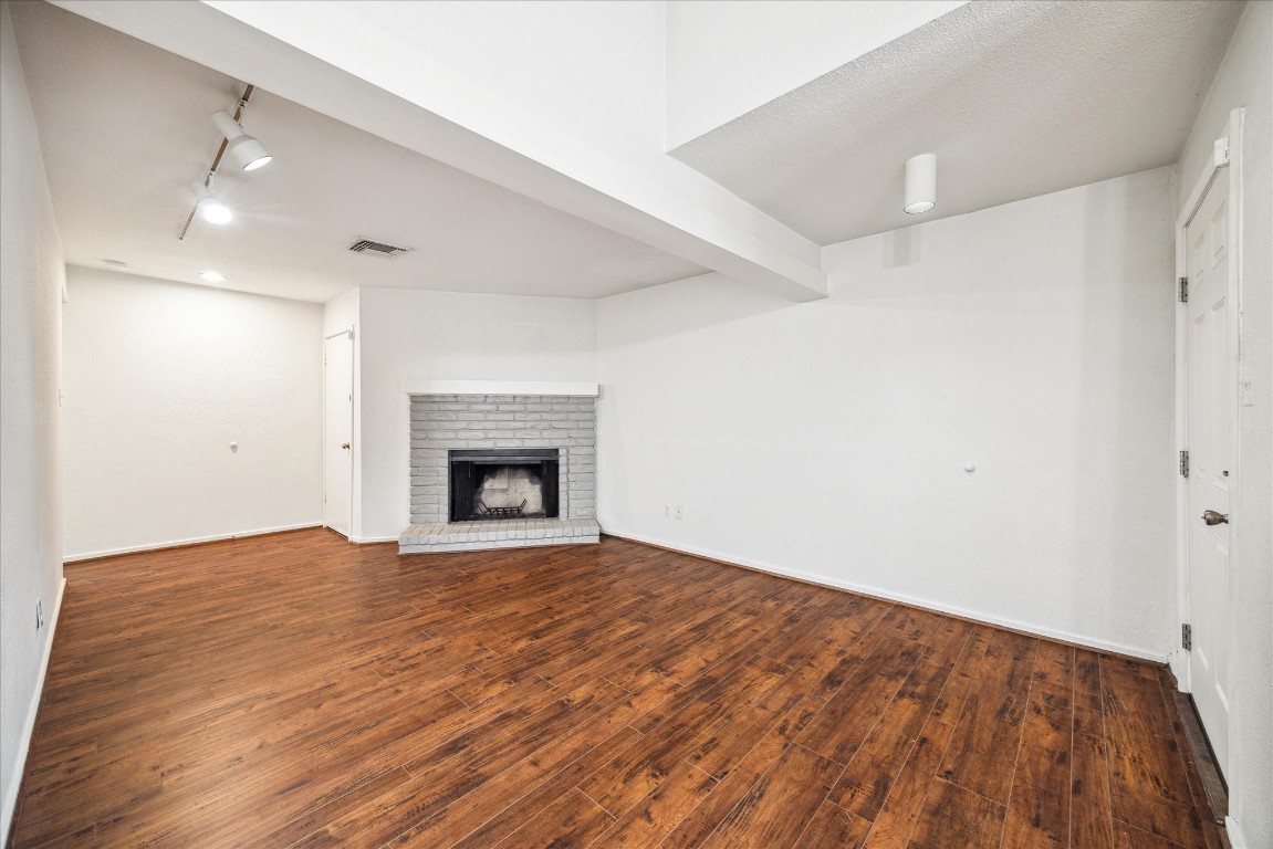 1864 South Gessner Road Houston, TX 77063 - Photo 9 of 17 a view of an empty room with wooden floor and a window