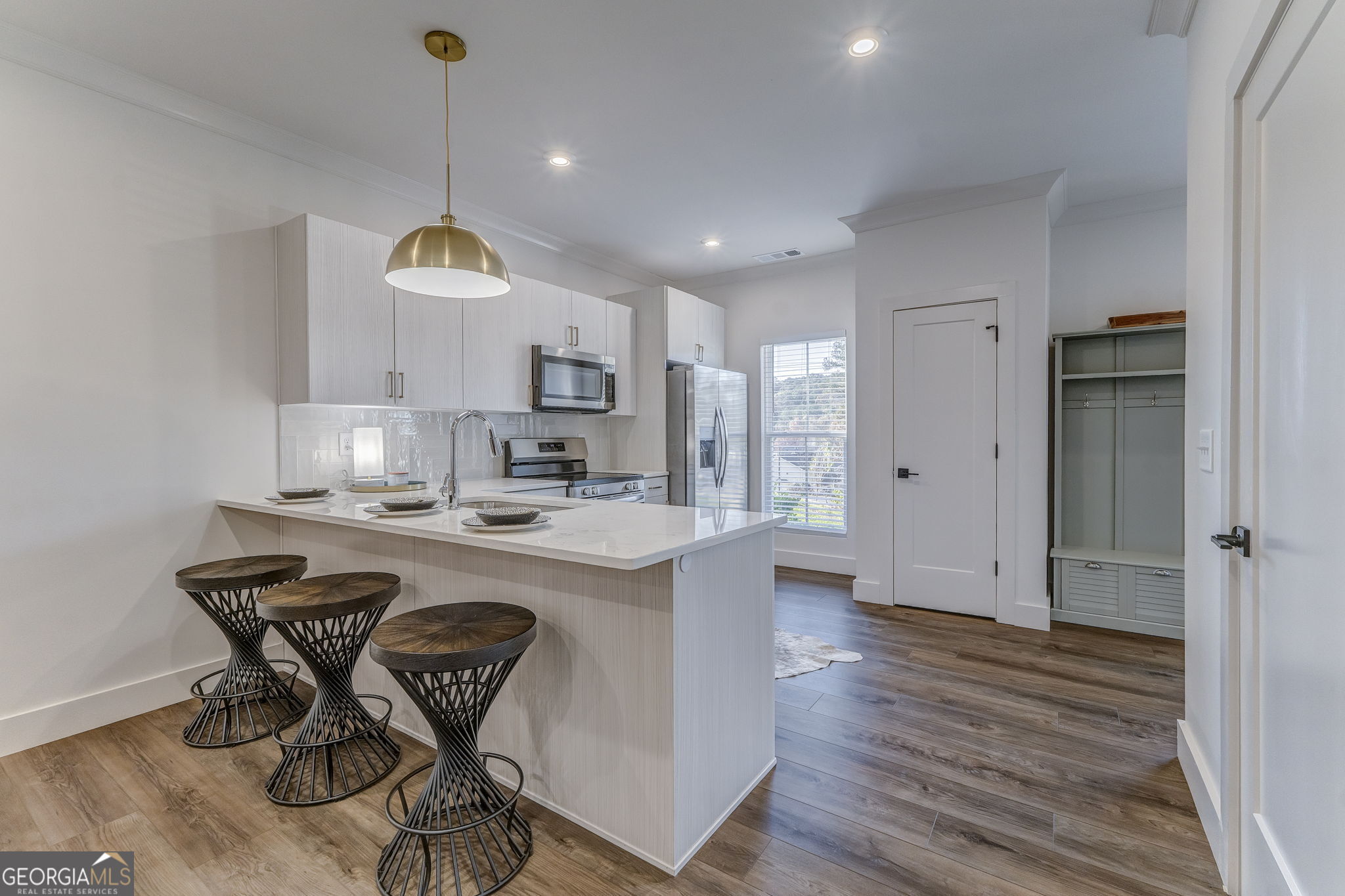 93 Chateau Drive Southeast Rome, GA 30161 - Photo 28 of 66 a kitchen with stainless steel appliances a table chairs refrigerator and microwave