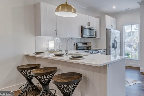 a view of an empty room and wooden floor