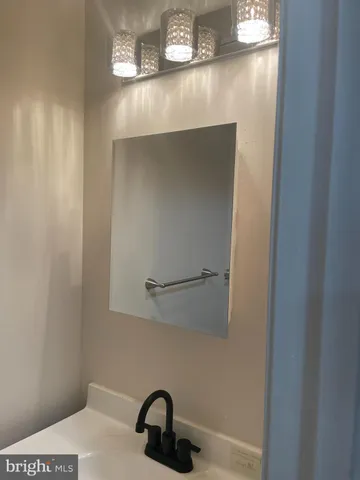 a bathroom with a sink and mirror