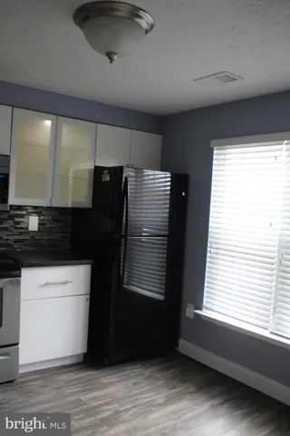 a kitchen with a refrigerator and window