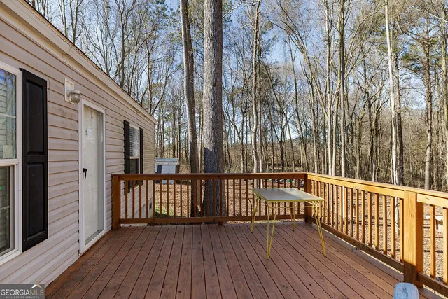 a view of a wooden balcony with wooden floor and fence