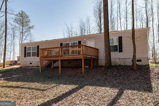 a wooden bench sitting in front of a house