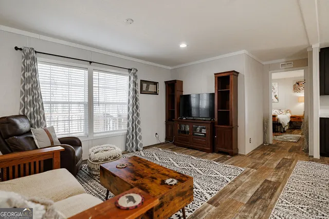 a living room with furniture and a flat screen tv