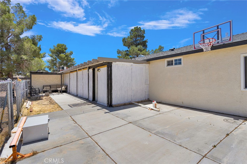 15471 Washoan Road Apple Valley, CA 92307 - Photo 29 of 38 a backyard of a house with table and chairs plants