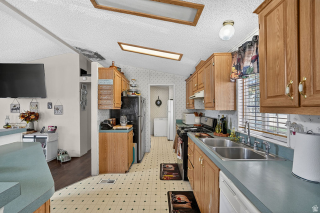 269 Mindella Way, Unit A Layton, UT 84041 - Photo 8 of 37 Kitchen with white appliances, wallpapered walls, light flooring, and wood finish cabinetry
