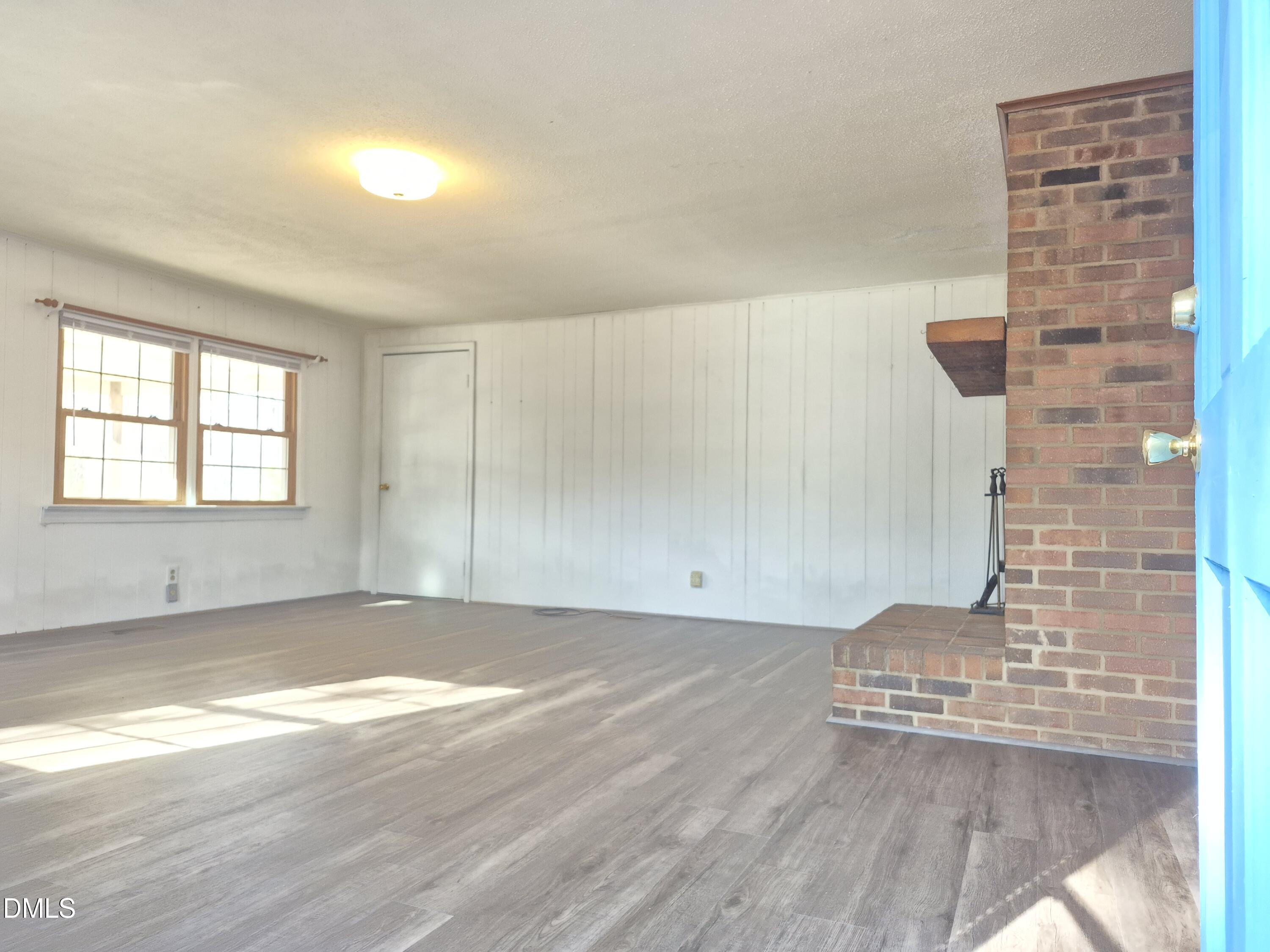 269 Beaver Dam Road Norlina, NC 27563 - Photo 11 of 33 a view of empty room with wooden floor and fan