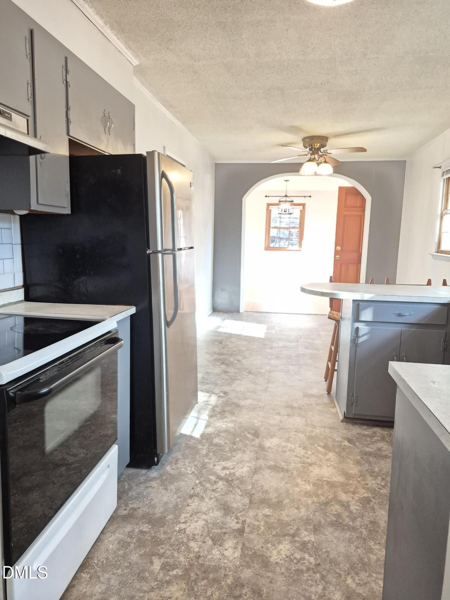269 Beaver Dam Road Norlina, NC 27563 - Photo 13 of 33 a kitchen with stainless steel appliances a refrigerator a stove and a sink