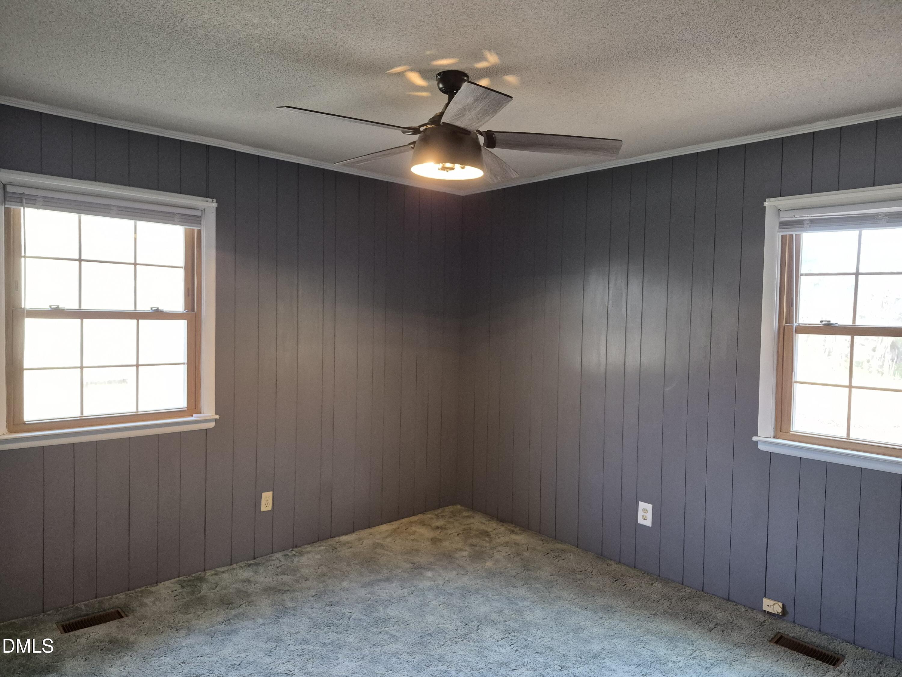 269 Beaver Dam Road Norlina, NC 27563 - Photo 17 of 33 an empty room with chandelier fan and windows