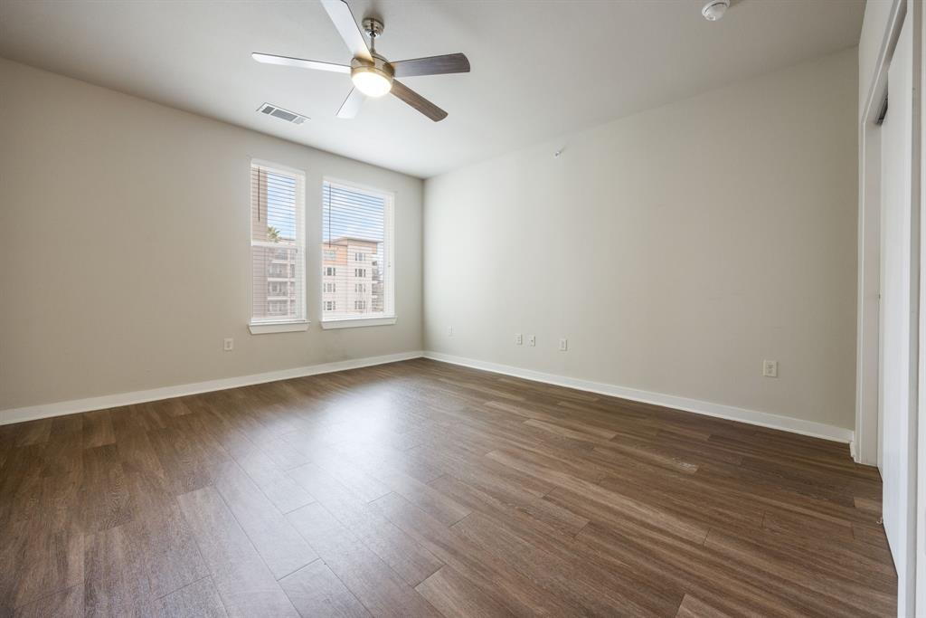 1900 Barton Springs Road, Unit 3013 Austin, TX 78704 - Photo 9 of 27 A versatile living space with light wood flooring and a refreshing ceiling fan.