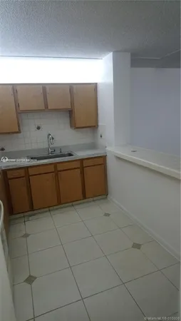 a kitchen with stainless steel appliances a sink stove and cabinets