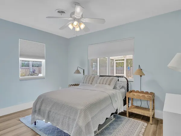 a bedroom with a white bed and a chandelier