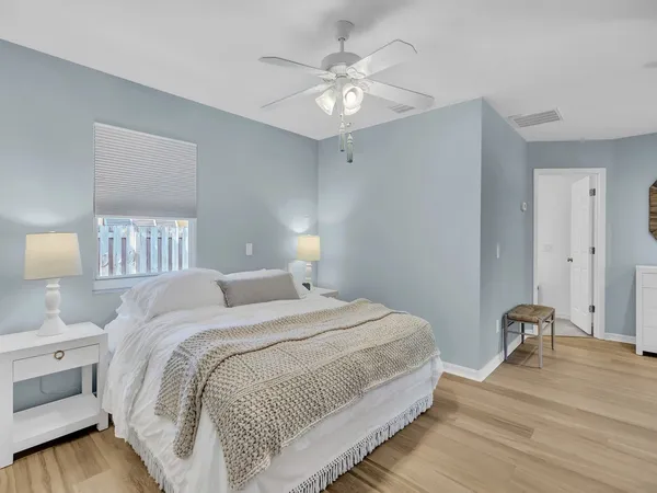 a view of a workspace room with wooden floor cabinet and a table