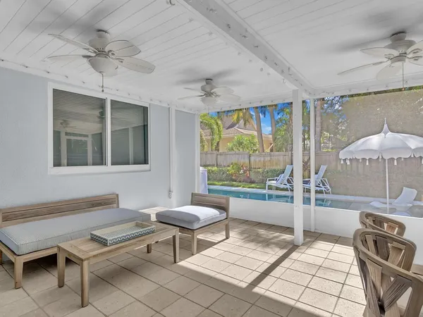 a view of a patio with chair and tables back yard of the house