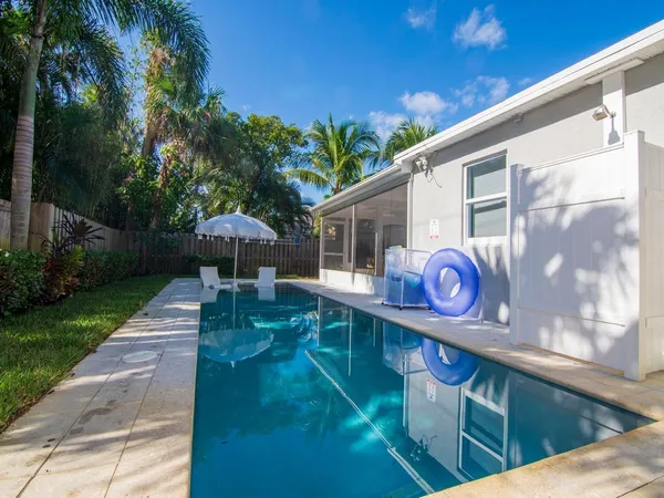 a view of a back yard with a table and chairs