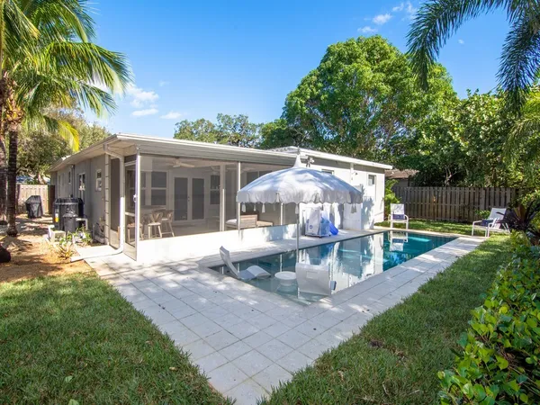 a view of a house with backyard sitting area and garden