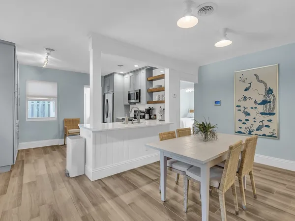 a view of a dining room with furniture and wooden floor