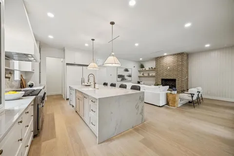 a kitchen with stainless steel appliances granite countertop a stove oven and a refrigerator
